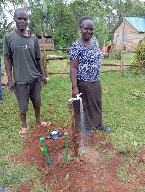 Customers beside their household water meter
